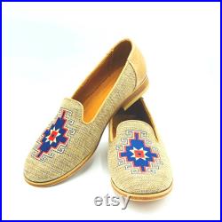 Tan shoe with blue and tan and blue accents and a leather sole