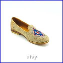 Tan shoe with blue and tan and blue accents and a leather sole
